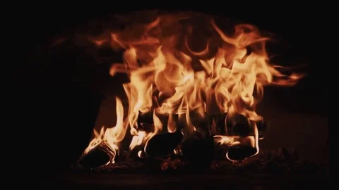 Hot red fire flames burning wood in dark room fireplace Stock Footage