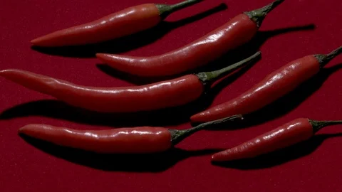 Hot red pepper rotates on a red background (video loop) Stock Footage 104144409