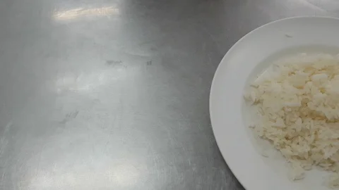Hot rice in a plate on the table 動画素材 100548824
