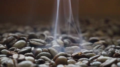 Hot roasted coffee beans have a soft smoke. Stock-Footage 182472022