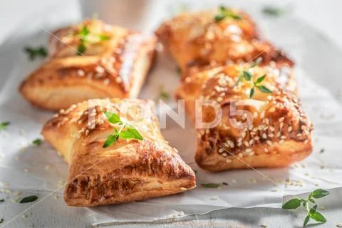 Hot sausage in puff pastry with thyme and sesame seeds Stock Photos