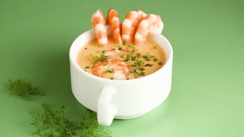 Hot savory shrimp chowder with dill and chives in elegant ceramic cup Stock Footage 323318154