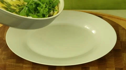 Hot scrambled eggs with arugula Video stock 61879699