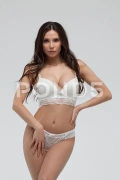 Pretty Woman Wearing White Bra And Panty In Studio Stock Photo