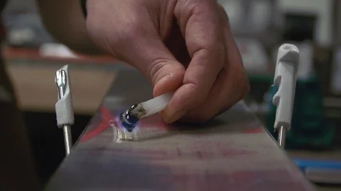 Hot Ski Wax Applied to Ski - Slow motion Video stock 90665582