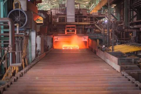 Hot slab are moving extract from furnace, In side steel making factory. Stock Photos