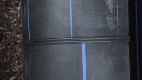 Hot solder seam on large diameter black plastic pipe. Stock Footage 287686421