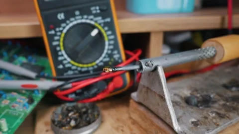 Hot Soldering Iron Tip with Melted Rosin and Solder on Metal Stand Stock Footage 338331627