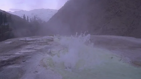 Hot spring in the mountains seethes water and steam comes Stock-Footage 123560992
