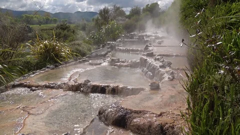 Hot spring water flowing through rocks Stock Footage 88259317