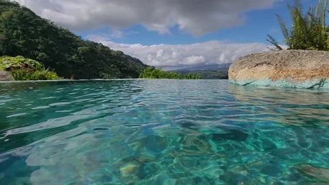 Hot springs infinity pool over looking the mountains  Stock Footage 257470976