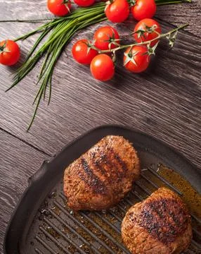 Hot steaks on pan Stock Photos