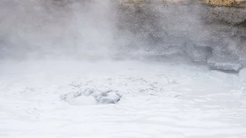 Hot steam bubbling boiling mud geyser in Hverir geothermal Iceland Myvatn Stock Footage 92762094