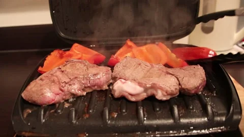 Hot steam griddle pan cooking meat Video stock 147645682