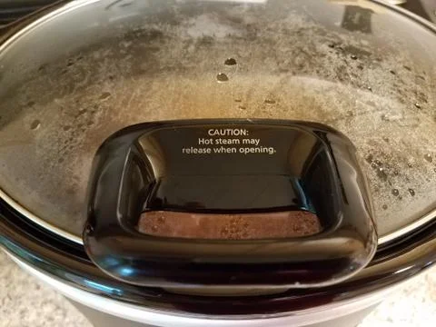 Hot steam may release when opening on hot pot cooker Stock Photos