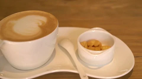 Hot steaming cup of coffee standing on a wooden table. morning coffee concept. Vídeo Stock 334648744