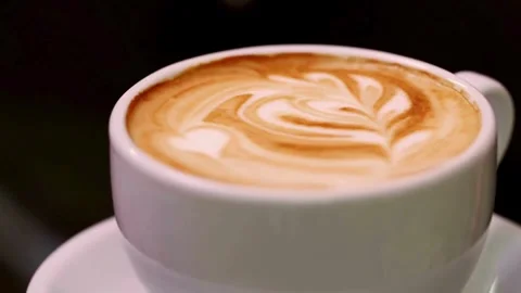Hot steaming cup of coffee standing on a wooden table. morning coffee concept. Stock-Footage 334648801