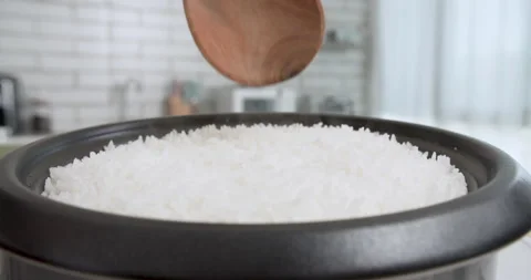 Hot Steaming Rice When Open Lid of rice cooker on table inside kitchen 動画素材 204845356