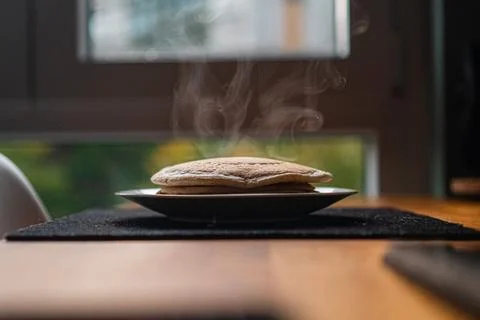 Hot Steaming Stack of Delicious Homemade Pancakes Sitting on a Wooden Table.. Stock Photos