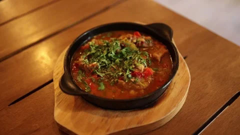 Hot stew with herbs in pan Stock Footage 331199828