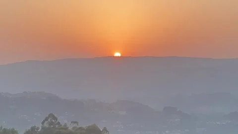 Hot summer day with sunset behind hill and tranquil green landscape 🌞🌄 Stock Footage 310965332