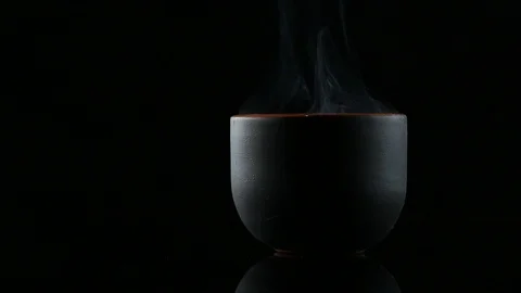 Hot tea on a black background Stock Footage 86942640