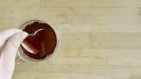 Hot tea brewing - Hand moving the tea bag up and down to infuse - Breakfast.. 스톡 동영상 231327025