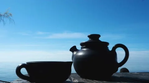 Hot tea on clay tea pot with beautiful sea view Stock Footage 130820033