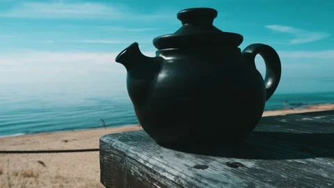 Hot tea on clay tea pot with beautiful sea view Stock Footage 130820206