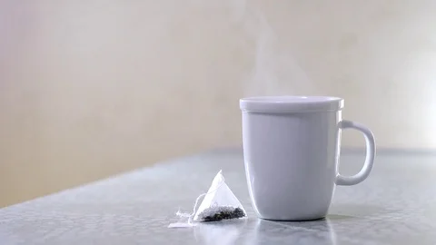 Hot tea in a Cup and a tea bag Stock Footage