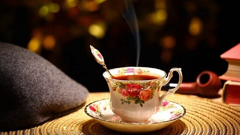 Hot tea cup gold bokeh hat smoking pipe book nobody hd footage Stock Footage 101070069