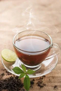 Hot tea of cup with slice of lemon on hemp sack for break fast and drinking.. Stock Photos