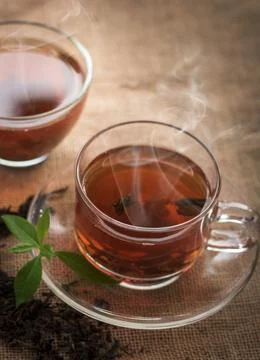 Hot tea of cup with slice of lemon on hemp sack for break fast and drinking.. Stock Photos