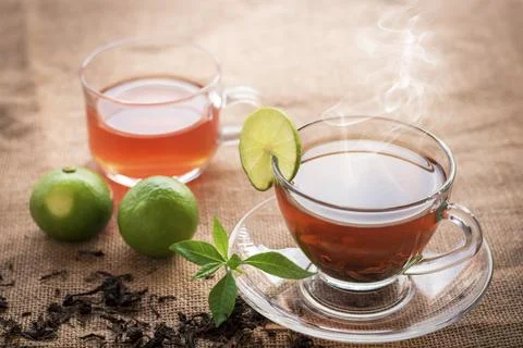 Hot tea of cup with slice of lemon on hemp sack for break fast and drinking.. Stock Photos