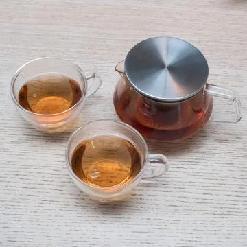 Hot tea cup on the table Stock Photos