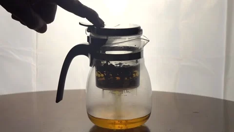 Hot tea flowing into kettle Stock Footage 162846874