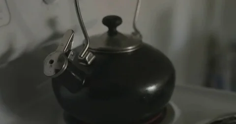 Hot tea kettle steaming on stove Video stock 78038234