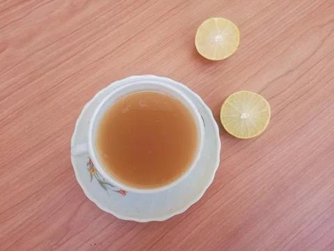 Hot tea with lemon slice top view isolated on wood background Stock Photos