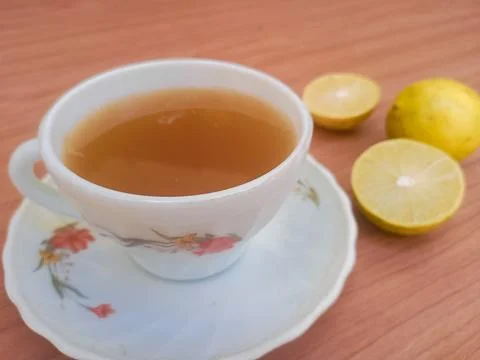 Hot tea with lemon slice top view isolated on wood background Stock Photos