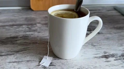 Hot Tea with Lemon Slice in White Mug Video stock 340340936