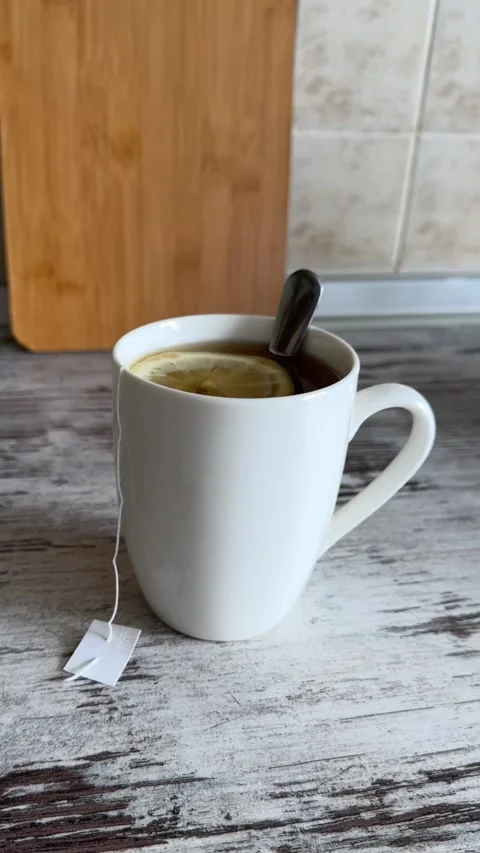 Hot Tea with Lemon Slice in White Mug Video stock 340340937