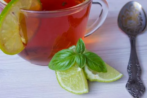 Hot tea with lime in a cup Stock Photos