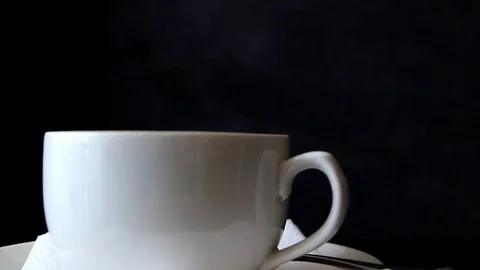 Hot tea is poured into the cup from teapot. Stock Footage 96572263