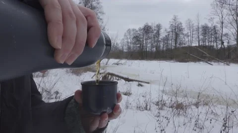 Hot tea poured from thermos Stock Footage 148442416
