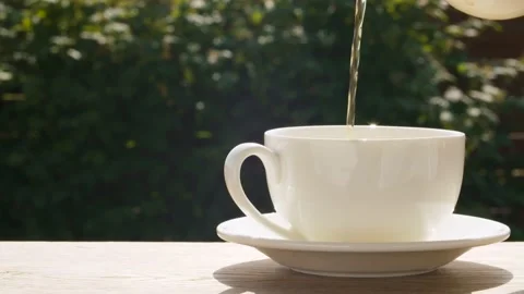 Hot tea pouring into a cup Stock Footage 135826417