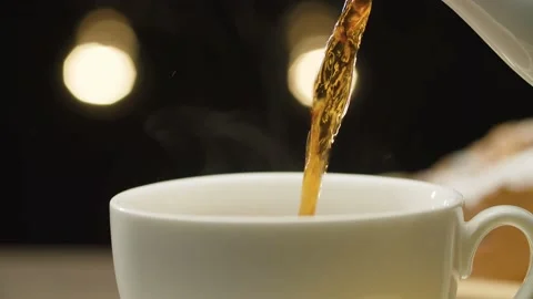 Hot tea pouring into a cup Stock Footage 140406366