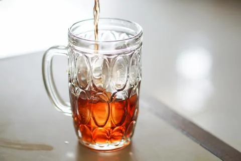 Hot Tea Pouring Into a Patterned Glass Mug Stock Photos