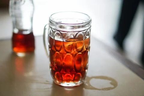 Hot Tea Pouring Into a Patterned Glass Mug Stock Photos