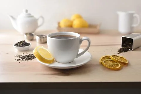 Hot tea on table with lemon tea and kitchen items Stock Photos