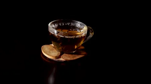 Hot tea in a transparent cup. tea is brewed in a cup. bowl on a wooden stand. Stock Footage 144455658